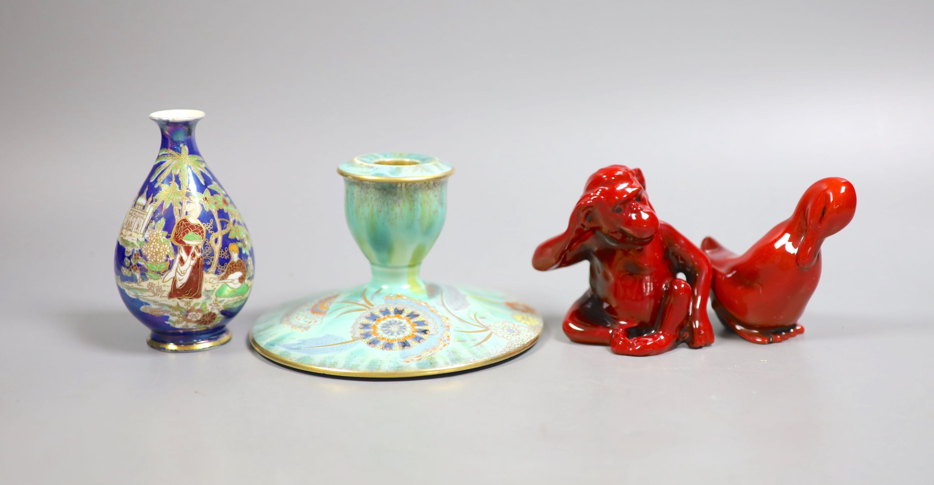 A Royal Doulton flambé figure of a monkey, 8.5 cm, a similar figure of a duck, a Carltonware lustre vase and a similar dwarf candlestick (4)